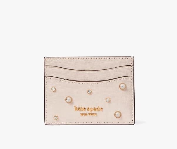 Fashionable card holder by Kate Spade featuring elegant design and iconic logo embellishment